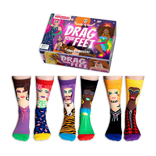 Set of colorful socks with Drag Queen faces and a box labeled 'Drag Your Feet' on a white background.